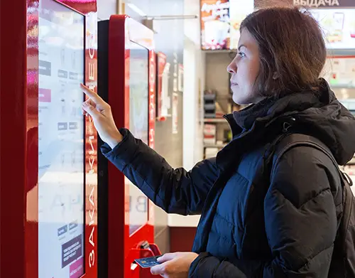 girl ordering from restaurant kiosk