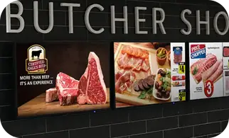 Digital menu boards over a butcher counter