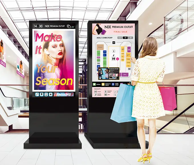 girl in front of interactive kiosks in retail environment